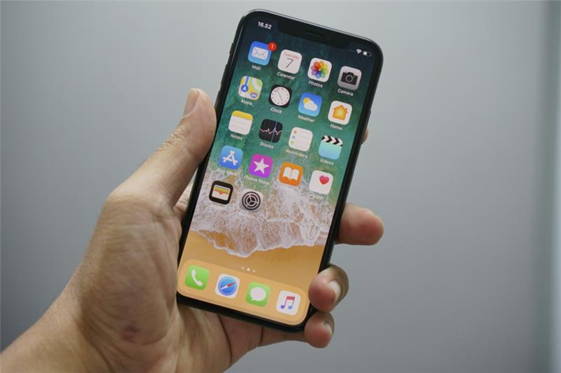 The End of the App article cover: hand holding an iPhone displaying the iOS home screen